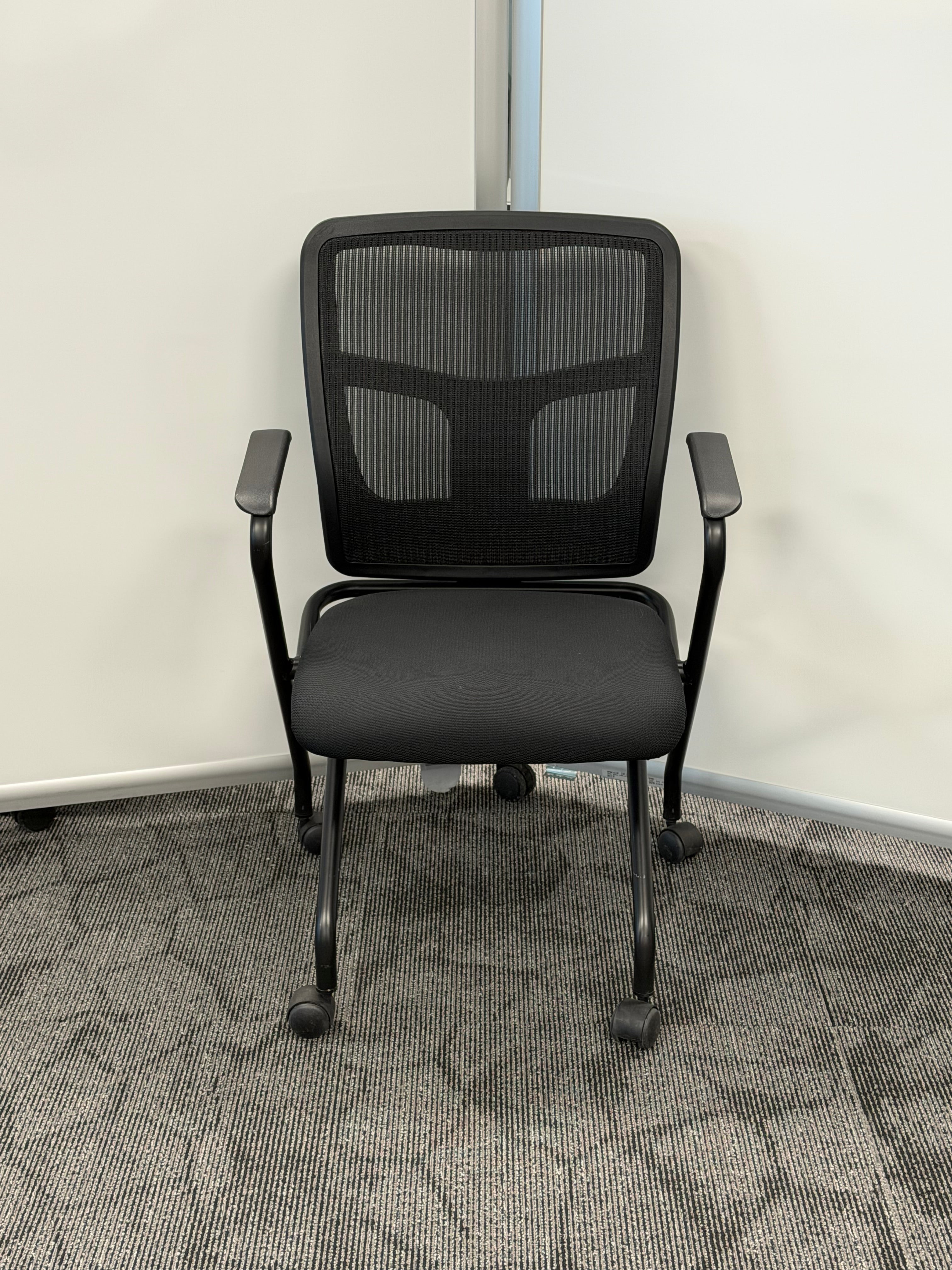 Nesting chair Black mesh back Black fabric seat Plastic arms Casters