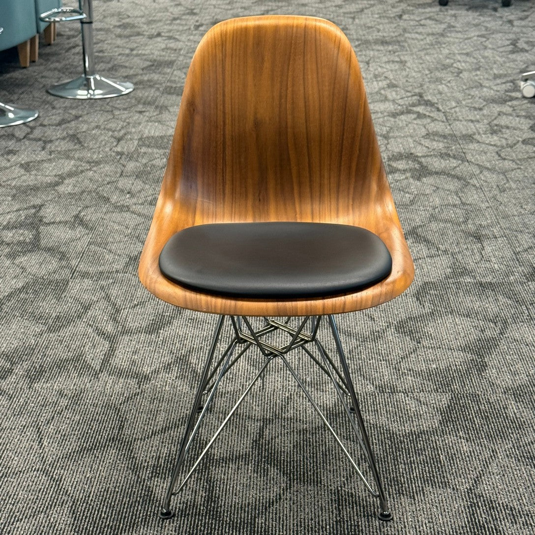 Eames Molded plywood side chair with black vinyl padded seat