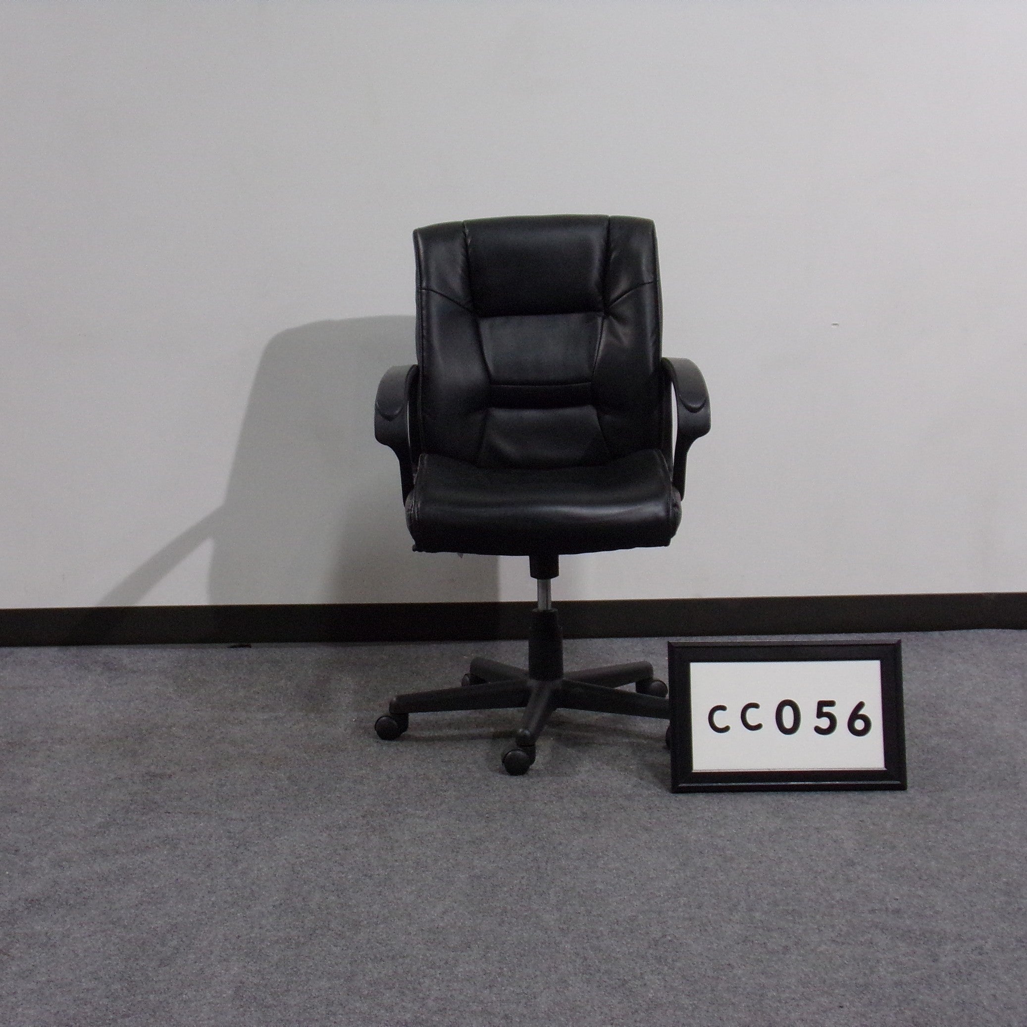 Conference chair Black vinyl seat and back Black plastic arms Height adjustable Tilt lock