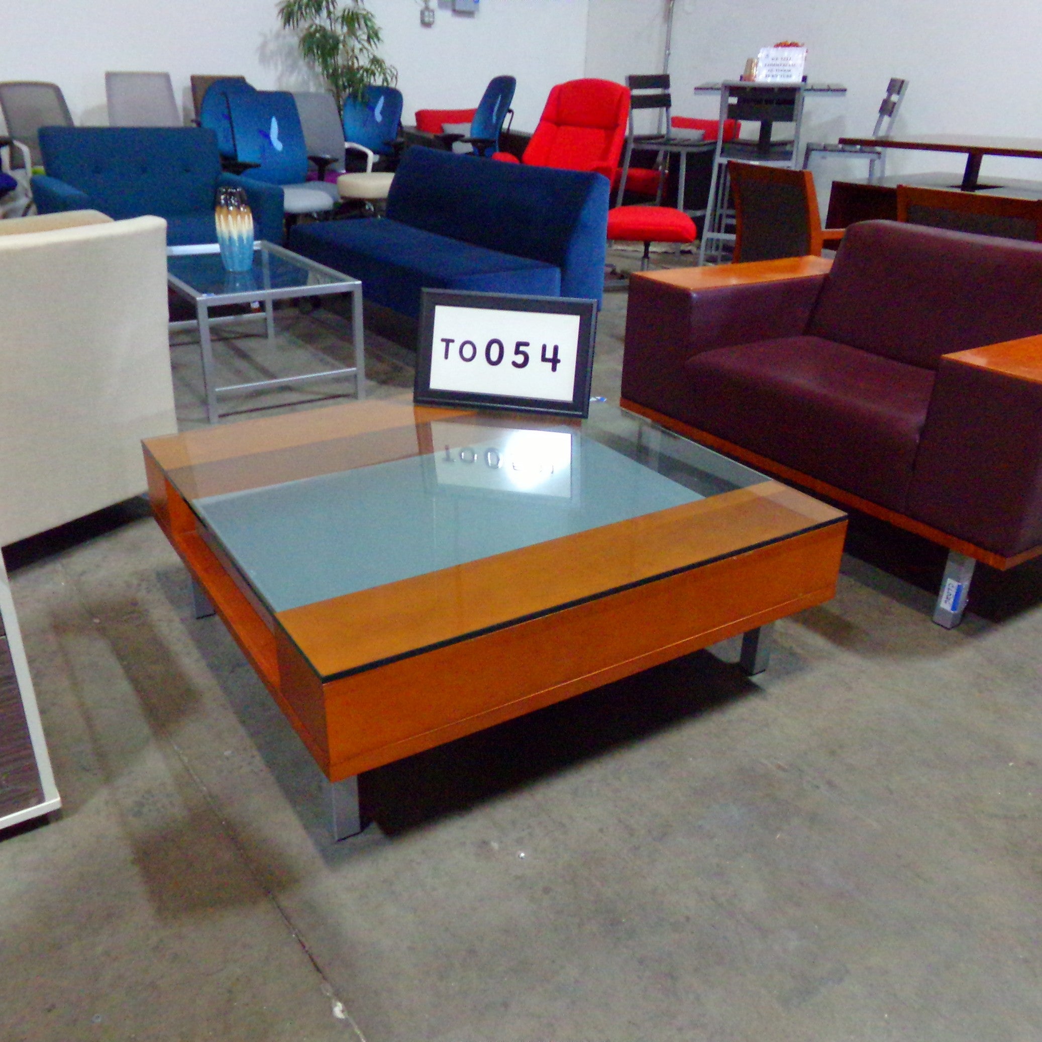JSI Connect Series coffee table..Cherry wood, glass top with silver metal insert and legs..42" squar