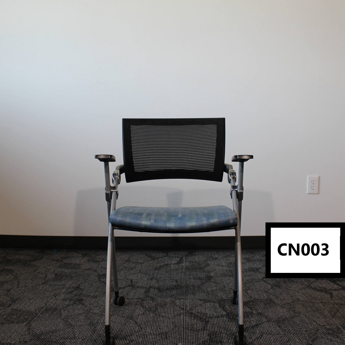 Nesting chair - Black mesh back nesting chair on casters with blue patterned vinyl seat