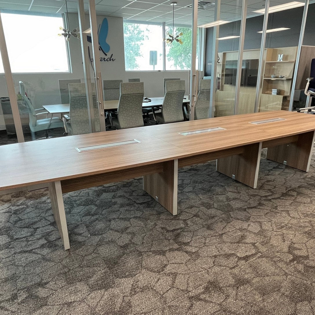 Modern walnut laminate conference table 14' x 4'  Boat shape with slab base 3 grommets