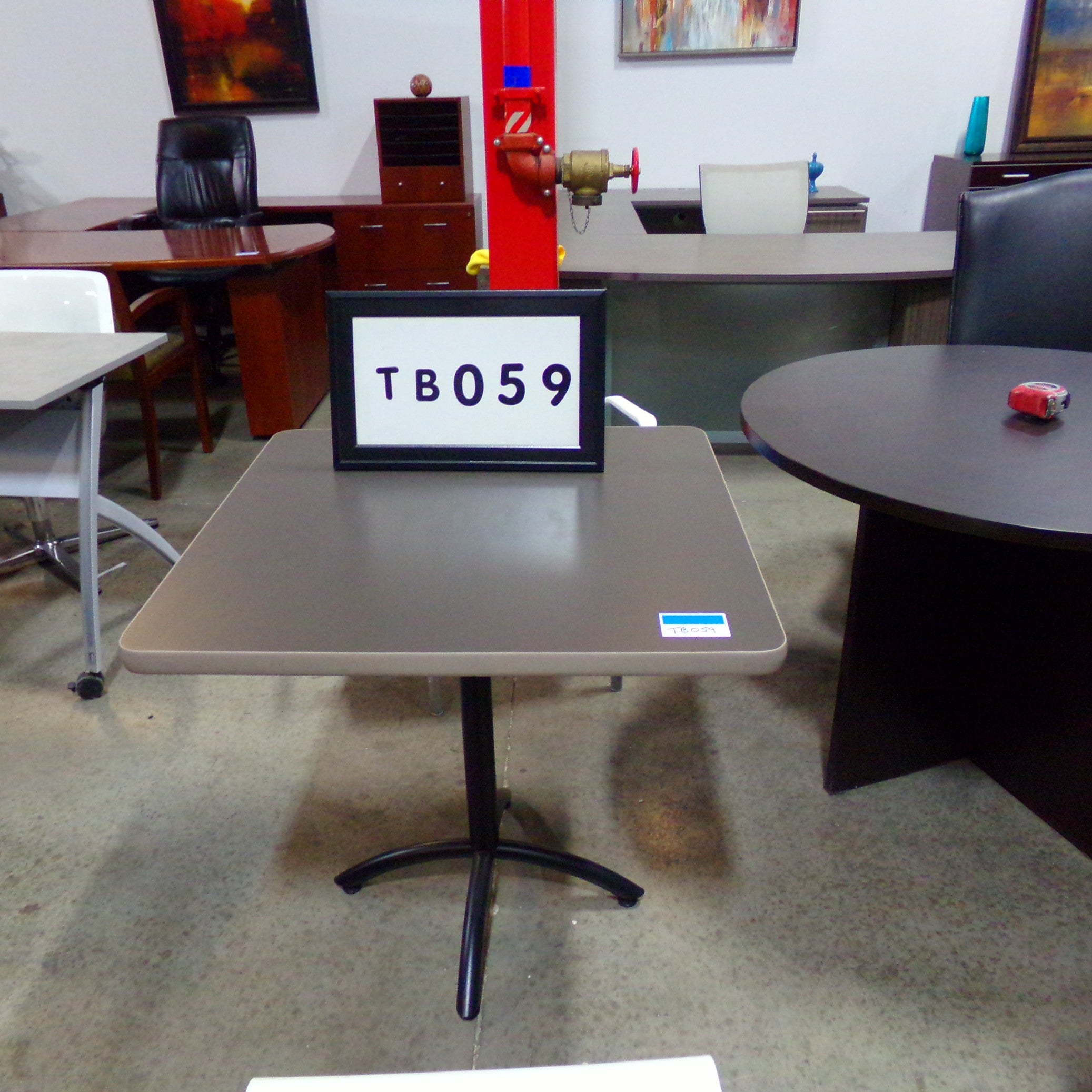 Dark gray laminate breakroom table with light grey trim..Black tubular x-base..30x30 square..30" hei